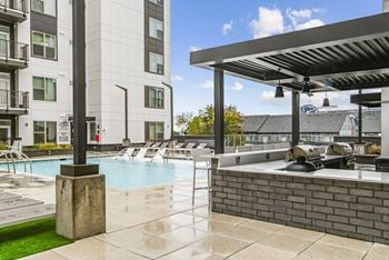 Spa and grilling area with buildings